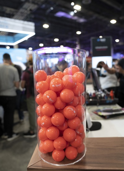 A glass jar full of orange balls with Spot by NetApp written on them