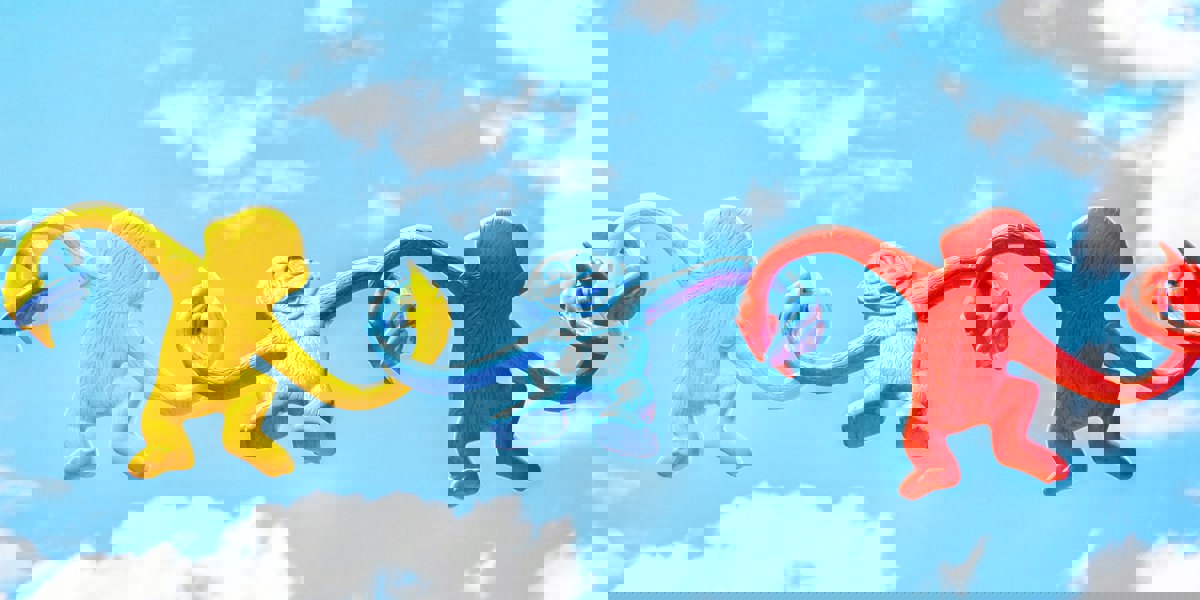 Colourful monkeys holding arms while floating in the sky