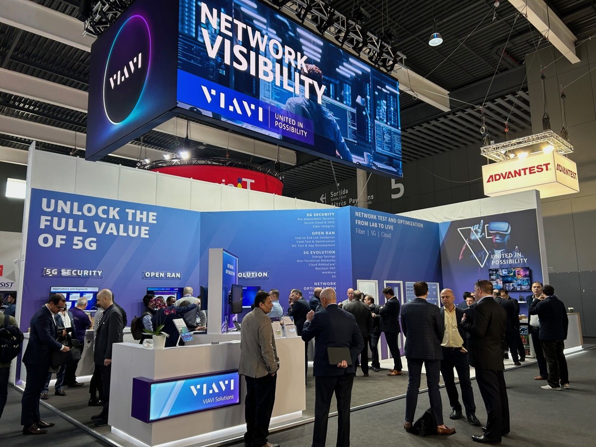 VIAVI booth at a tradeshow with delegates having conversations