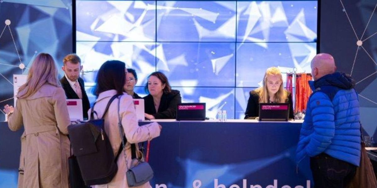 Delegates being helped at a registration and help desk