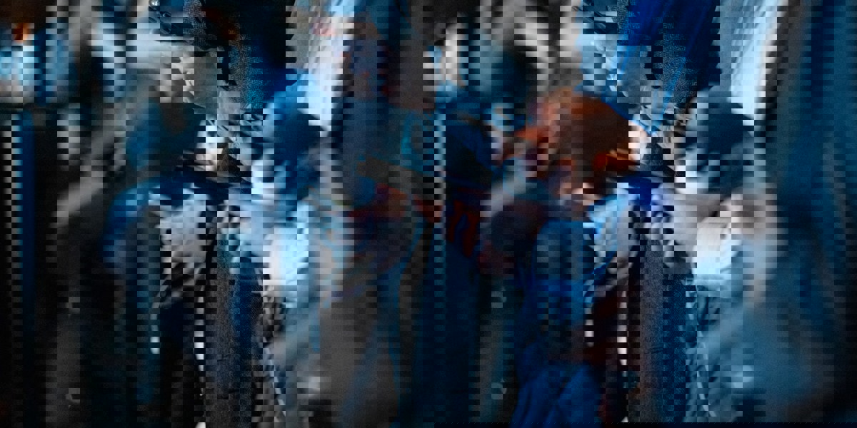 Close-up of multiple people holding mobile phones, highlighting digital connectivity and smartphone usage.