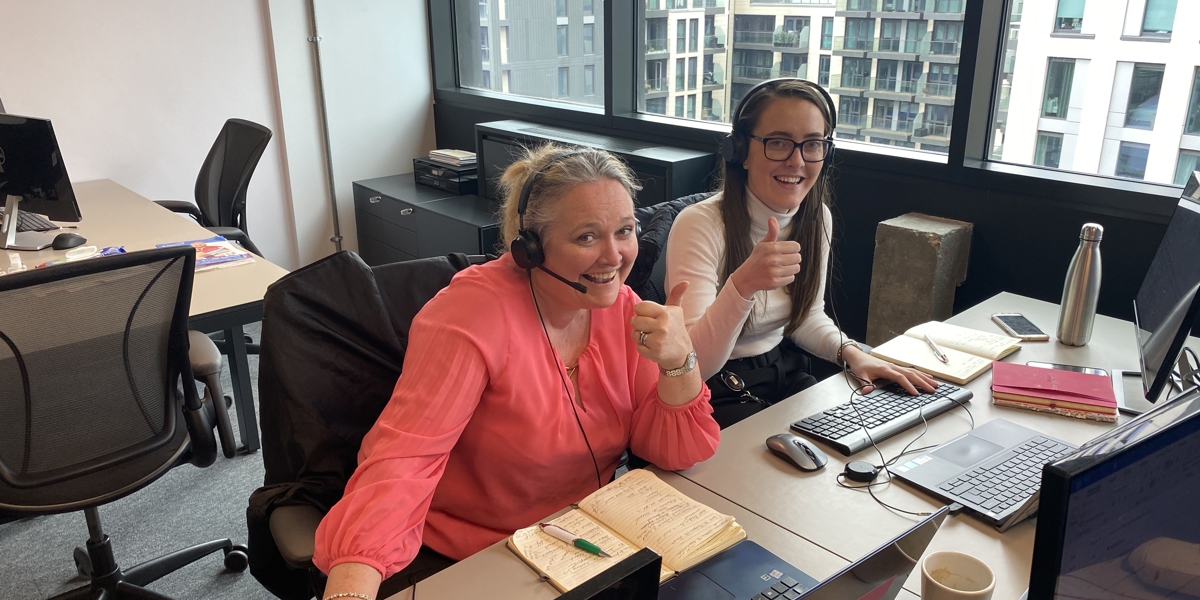 Debbie and Emily sitting at their desk working in the OE office