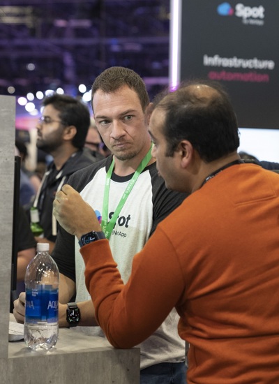 Two people talking at a tradeshow stand