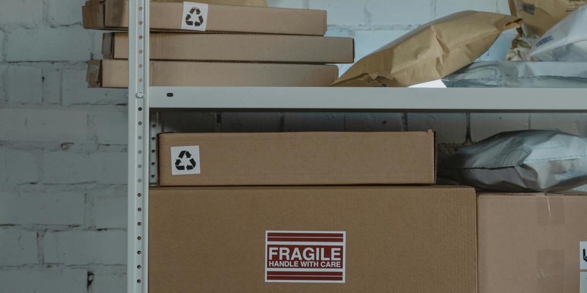 Warehouse shelving stacked with fragile boxes for event inventory management