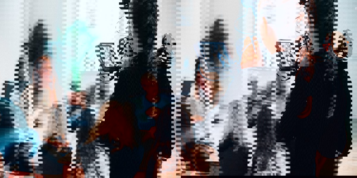 Blurred image of a videographer filming a conversation