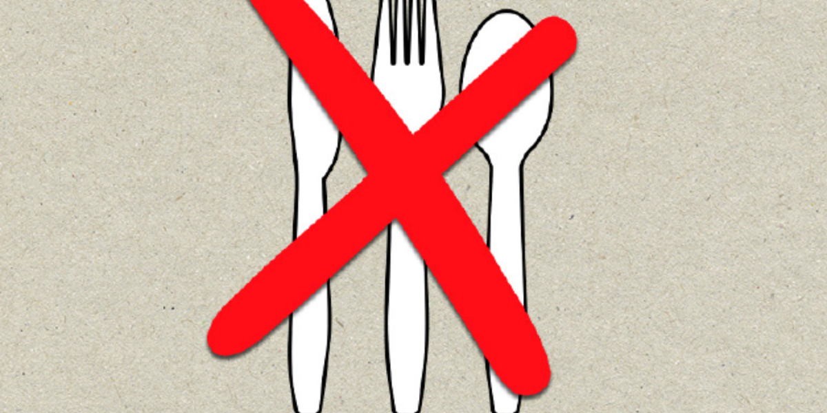 Plastic knife, fork, and spoon with a large red X over them, indicating no plastic cutlery allowed.