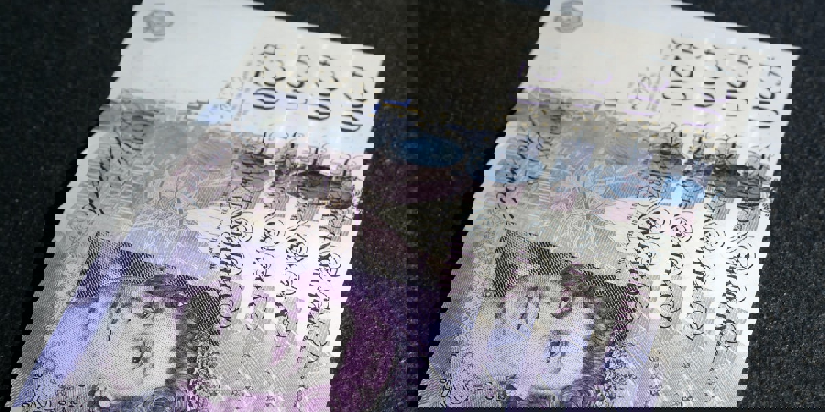 Four £20 notes placed on a table