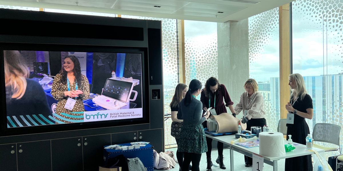 Medical demonstration broadcast to attendees in a modern office setting at BMFMS ASM