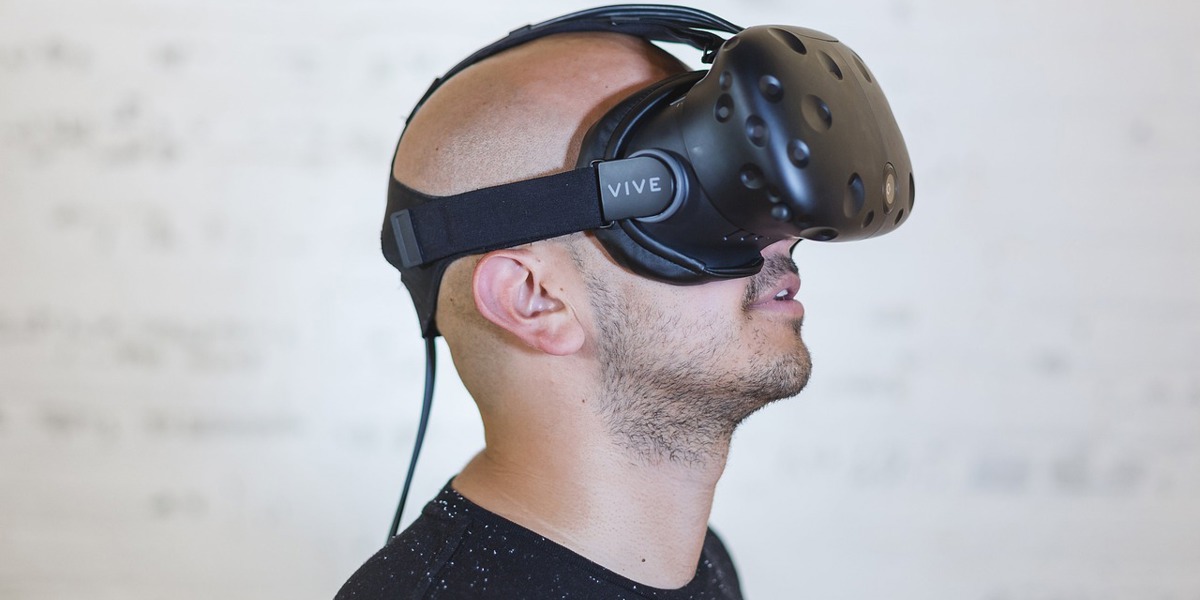 Man looking upward while wearing a VR headset