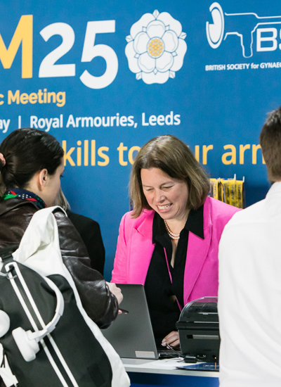 Registration desk at the BSGE ASM 2025 - delegates interacting with OE team members