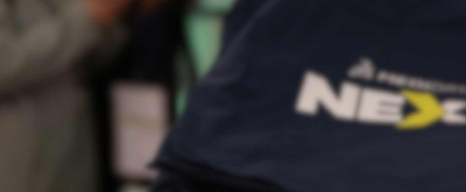 A blurred image of navy blue tote bags