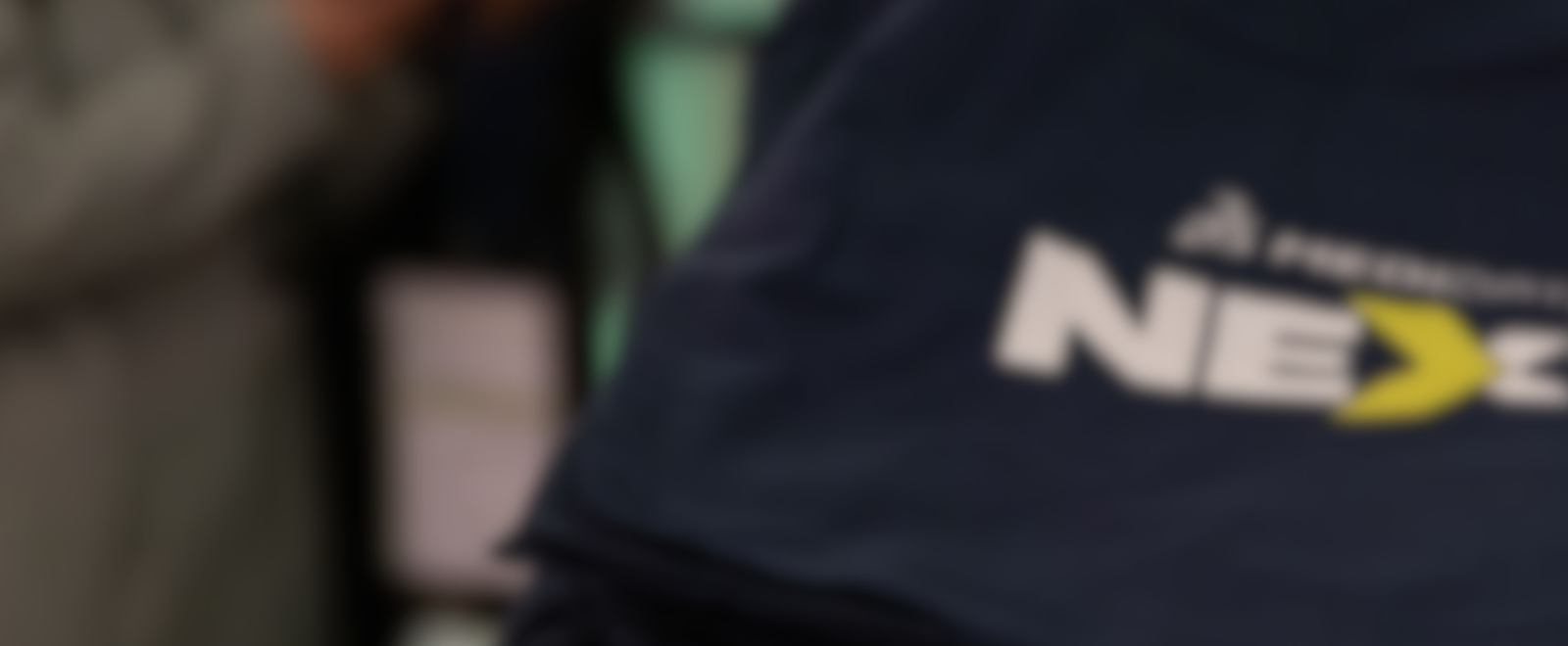 A blurred image of navy blue tote bags