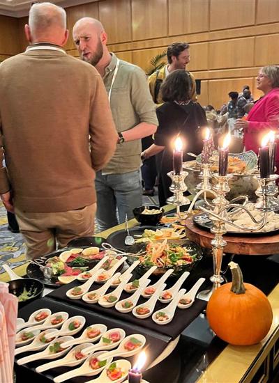 A dining table with canapes a pumpkin and a candelabra