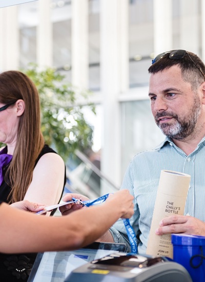 A delegate receiving their badge at registration